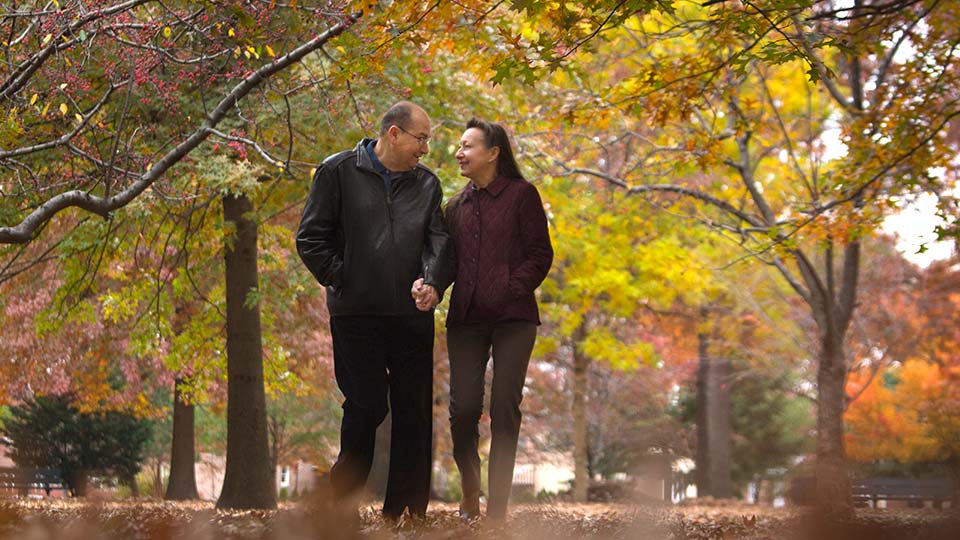 Couple Walking in Autumn Leaves