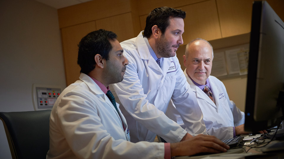 Radiation Oncologist Dr. Alec Kimmelman Reviews Images with Staff