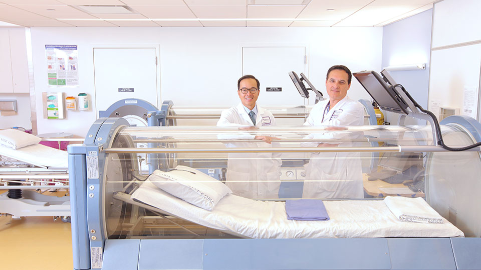 Dr. Frank Ross and Dr. Ernest Chiu with Hyperbaric Oxygen Therapy Chamber
