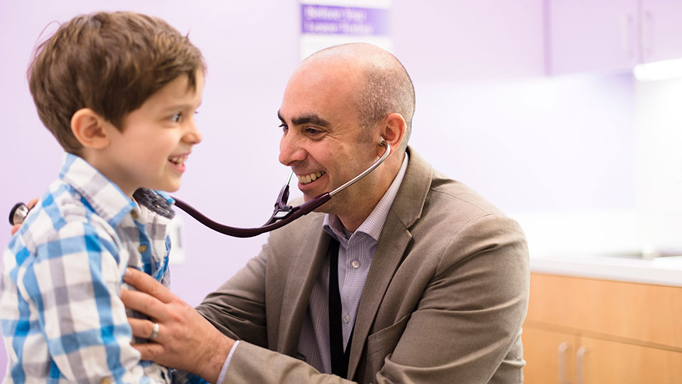Neuro-oncologist Dr. Kaleb Yohay Examines Pediatric Patient